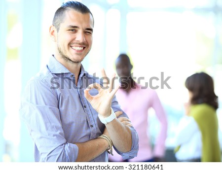 Businessman showing OK sign with his thumb up