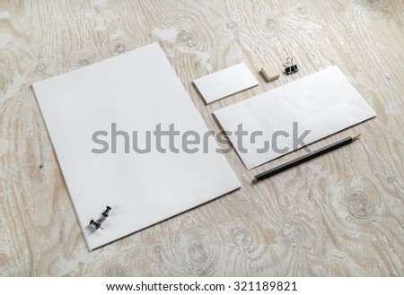 Blank stationery set on light wooden background. Template for design presentations and portfolios. Photo.