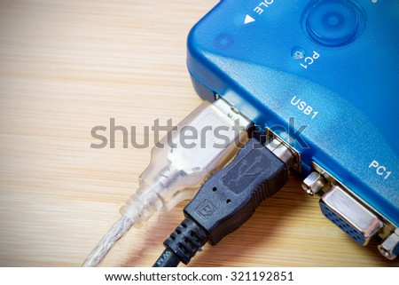 Close-up details of a blue digital electronic computer kvm switch with USB cables attached Royalty-Free Stock Photo #321192851