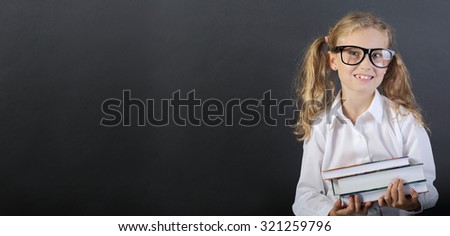 Young girl with books on board background