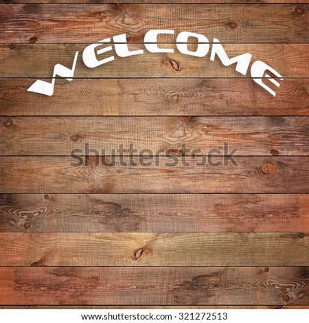 Vintage WELCOME sign on natural wooden surface. Closeup.