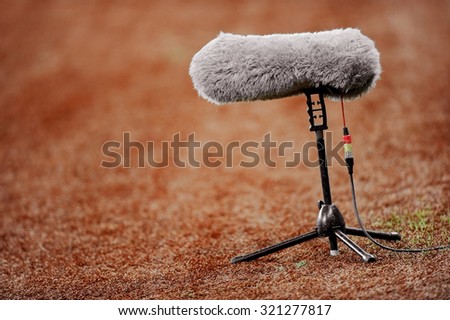 Big and furry sport microphone on a soccer field