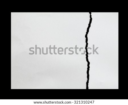 tearing paper into two pieces on black background with copy space for text Royalty-Free Stock Photo #321310247