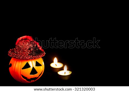 Halloween decoration of orange plastic Jack-O-Lantern isolated on black , abstract background to Halloween toy concept.