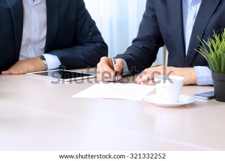 business colleagues working together. Businessman is signing a contract