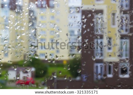 Blur the background: rain, raindrops on the window, the street