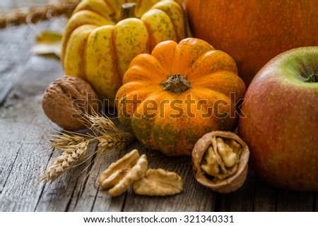 Thanksgiving decorations - pumpkins nuts oat, rustic wood background