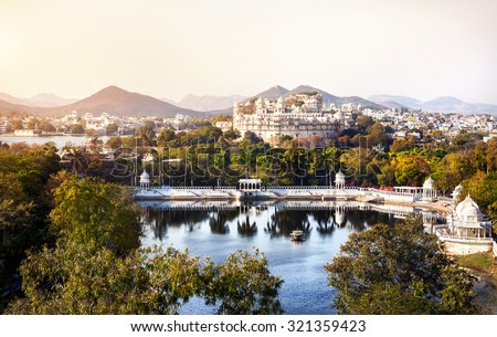 Lake Pichola with City Palace view in Udaipur, Rajasthan, India Royalty-Free Stock Photo #321359423