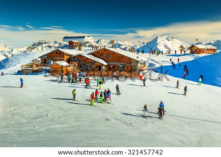 Wooden chalets and ski slopes in the French Alps,Les 3 Vallees,Menuires,France,Europe Royalty-Free Stock Photo #321457742