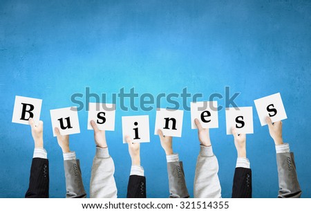 Group of business people holding in hands cards with letters 