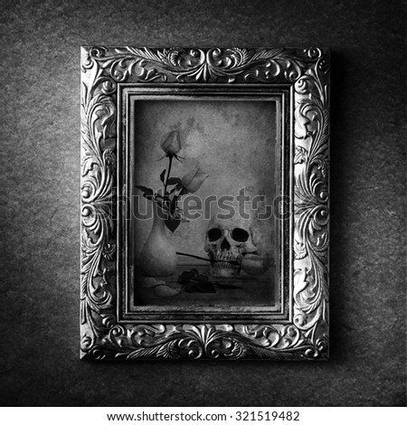 Vintage photo frame, photo of skull with rose over grunge background, halloween concept, black and white 