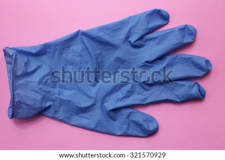 Sterile surgical glove on pink background