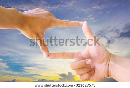 Photo sight:Frame made of hands with sunset sky