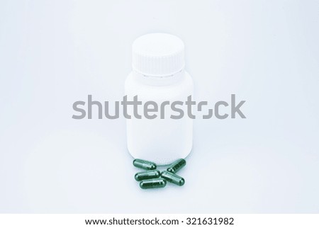 medicine capsules scattered on a white background
