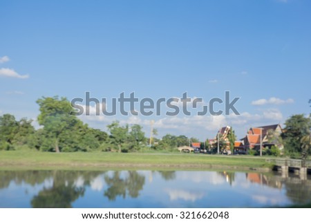 Blurred lake and tree on background