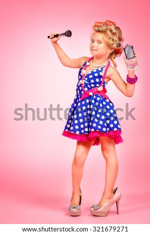 Pretty little girl in her mother's shoes and hair curlers. Kid's fashion, cosmetics. Pin-up style.