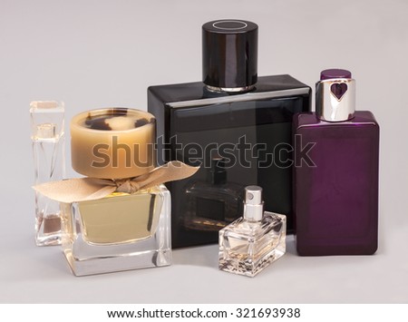 men's and woman perfume in bottles on gray background Royalty-Free Stock Photo #321693938