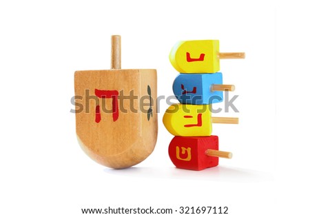 wooden colorful dreidels (spinning top) for hanukkah jewish holiday isolated on white
