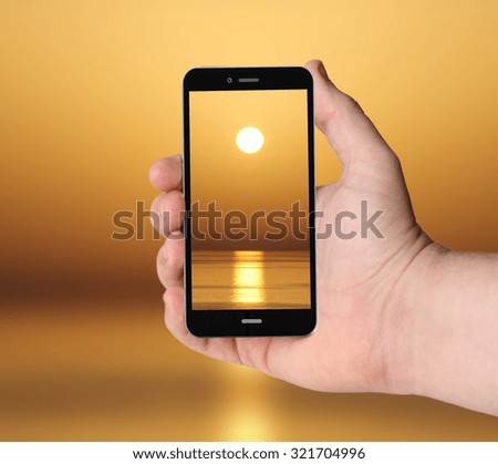 hand with digital generated smartphone taking a picture of beautiful sunset.