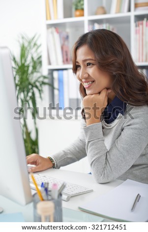 Portrait of smiling Asian office manager at her workplace