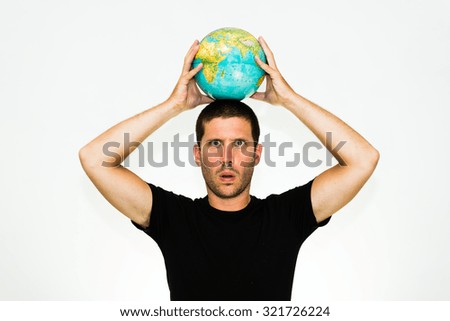 close-up of smiling caucasian man holding a world globe over his head - conceptual image isolated on white background with copyspace