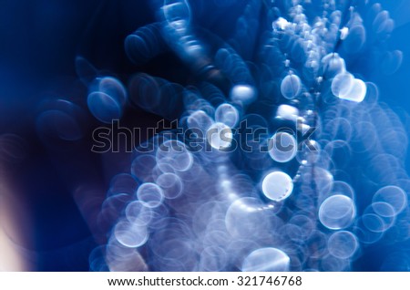 Abstract blurry blue background with lines and curves and white bubbles. Out of focus photo