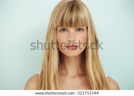 Young blond woman on blue background