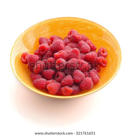 raspberries on a plate on a white  background .Isolated