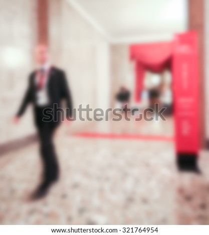 People walk, generic background, intentionally blurred post production.