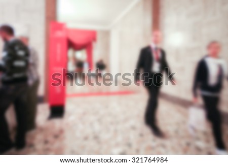 People walking, entertainment show generic background, intentionally blurred post production.