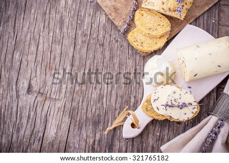 Meat loaf of fresh homemade butter with lavender on a wooden background. Top view. Horizontal. The concept of natural organic food. Selective Focus