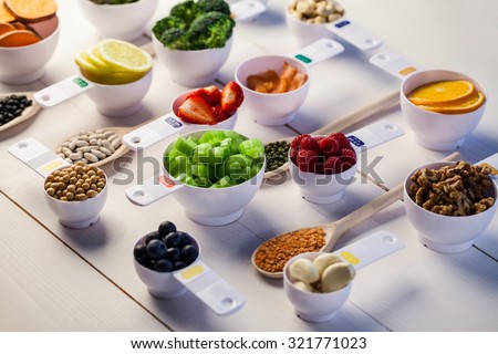 Portion cups of healthy ingredients on wooden table Royalty-Free Stock Photo #321771023