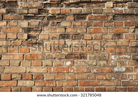 Damaged red aged brick wall background. 