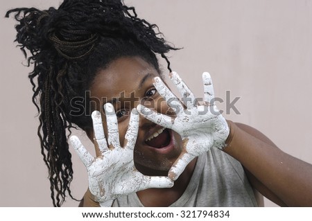 girl with dirty hands making a sign