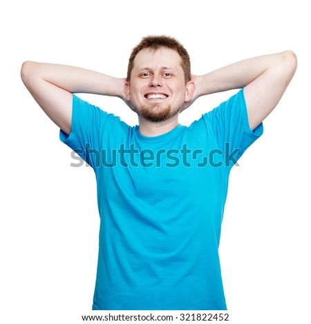 You deserve a rest! Portrait of a positive young man standing in blank blue t-shirt smiling, relaxing and holding hands behind his head