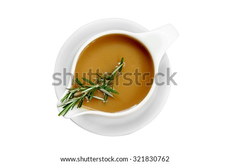 Gravy sauce with rosemary in a gravy boat on white background, isolated Royalty-Free Stock Photo #321830762
