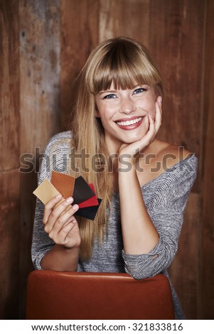 Young woman with swatches, smiling