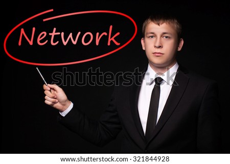 Man Hand specify, writing Network with Red Pen on visual black screen. Isolated on black. Business, technology, internet concept.