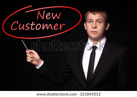 Man Hand specify, writing New Customer with Red Pen on visual black screen. Isolated on black. Business, technology, internet concept.