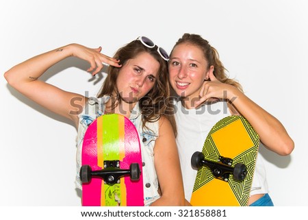 Friends with their skateboards making phone gesture