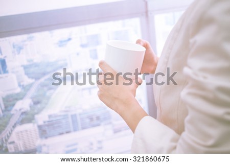 Close-up of female hand holding mug