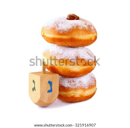 image of jewish holiday Hanukkah with donuts and wooden dreidel (spinning top). isolated on white