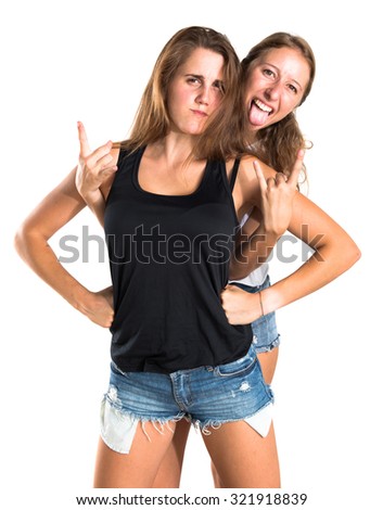 Two friends making horn gesture 