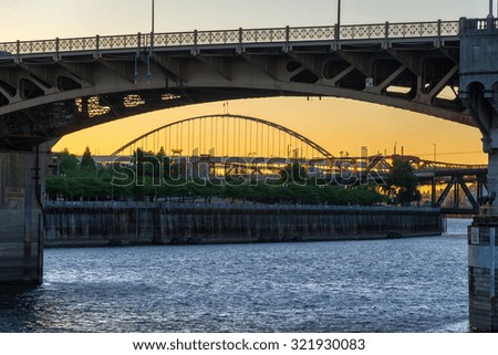 View of the Burnside Bridge and Willamette River at sunset in Portland, Oregon