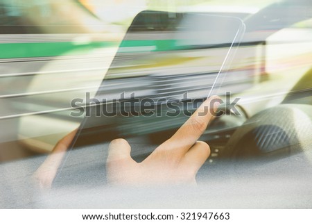 Using digital tablet double exposure and blurred view of car on city street 