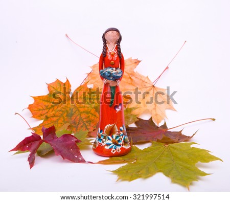 doll on a background of leaves