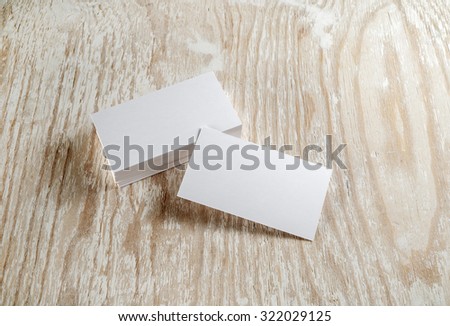 Photo. Blank business cards with soft shadows on light wooden background. Template for branding identity. For design presentations and portfolios.