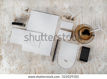 Photo. Blank stationery and corporate identity set on light wooden background. Mock-up for graphic designers portfolios. Top view.