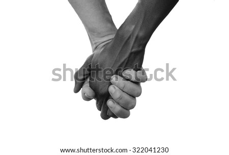 Black and White Hold Hands for Africa Union Peace Love. A beautiful shot with lots of possible background symbols. No to Racism! White woman holds hands with a little native African girl, in Mali.  Royalty-Free Stock Photo #322041230