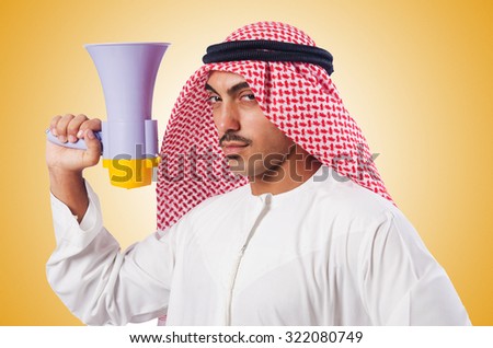 Arab man shouting through loudspeaker Royalty-Free Stock Photo #322080749
